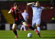 26 October 2022; Ben Lynch of Longford Town in action against Stephen Walsh of Galway United during the SSE Airtricity League First Division play-off semi-final first leg match between Longford Town and Galway United at Bishopsgate in Longford. Photo by Ben McShane/Sportsfile