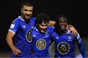 26 October 2022; Phoenix Patterson of Waterford, centre, celebrates with teammates Wassim Aouachria, left, and Junior Quitirna after scoring their side's second goal during the SSE Airtricity League First Division play-off semi-final first leg match between Treaty United and Waterford at Markets Field in Limerick. Photo by Seb Daly/Sportsfile