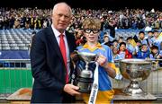 27 October 2022; St Marys BNS captain Theo Duggan is presented with the cup by Barney Rock after beating Scoil Mhuire BNS during day one of the Allianz Cumann na mBunscoil Football Finals at Croke Park in Dublin. Photo by Eóin Noonan/Sportsfile
