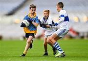 27 October 2022; Rossa Sweeney of St Mary's BNS in action against Bobby Harris, right, and Senan Keenan of Scoil Mhuire BNS during day one of the Allianz Cumann na mBunscoil Football Finals at Croke Park in Dublin. Photo by Eóin Noonan/Sportsfile