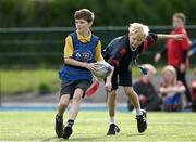 27 October 2022; Eliott Brickley of Scoil Assaim Boys National School, left, during the Leinster Rugby Primary School Tag Blitz at Clontarf RFC in Dublin. Photo by Harry Murphy/Sportsfile