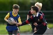 27 October 2022; Eliott Brickley of Scoil Assaim Boys National School, left, during the Leinster Rugby Primary School Tag Blitz at Clontarf RFC in Dublin. Photo by Harry Murphy/Sportsfile