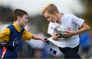 27 October 2022; Joshua Lambert of Belgrove Junior Boys' School, right, during the Leinster Rugby Primary School Tag Blitz at Clontarf RFC in Dublin. Photo by Harry Murphy/Sportsfile