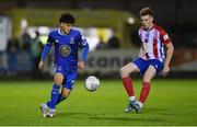 26 October 2022; Phoenix Patterson of Waterford in action against Jack Lynch of Treaty United during the SSE Airtricity League First Division play-off semi-final first leg match between Treaty United and Waterford at Markets Field in Limerick. Photo by Seb Daly/Sportsfile