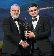 28 October 2022; Cillian McDaid of Galway is presented with his PwC All-Star award by Uachtarán Chumann Lúthchleas Gael Larry McCarthy during the PwC All-Stars Awards 2022 show at the Convention Centre in Dublin. Photo by Ramsey Cardy/Sportsfile