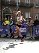 30 October 2022; Courtney Mc Guire, from Clonmel AC, crosses the line to finish second in the 2022 Irish Life Dublin Marathon. 25,000 runners took to the Fitzwilliam Square start line to participate in the 41st running of the Dublin Marathon after a two-year absence. Photo by Harry Murphy/Sportsfile
