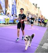 30 October 2022; Beáta Kis, from Dublin, and her dog Casper, compete in the 2022 Irish Life Dublin Marathon. 25,000 runners took to the Fitzwilliam Square start line to participate in the 41st running of the Dublin Marathon after a two-year absence. Photo by Harry Murphy/Sportsfile
