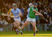 30 October 2022; David Woulfe of Kilmallock scores a point despite the attention of Mike Foley, left, and William Henn of Na Piarsaigh during the Limerick County Senior Club Hurling Championship Final match between Kilmallock and Na Piarsaigh at the TUS Gaelic Grounds in Limerick. Photo by Ben McShane/Sportsfile