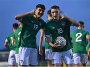 30 October 2022; Richard Vodo of Ireland, left, celebrates with teammate James Roche after scoring their side's first goal during the Victory Shield match between Republic of Ireland and Wales at the RSC in Waterford. Photo by Seb Daly/Sportsfile