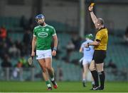 30 October 2022; Philip O'Loughlin of Kilmallock is issued a yellow card by referee Johnny Murphy during the Limerick County Senior Club Hurling Championship Final match between Kilmallock and Na Piarsaigh at the TUS Gaelic Grounds in Limerick. Photo by Ben McShane/Sportsfile