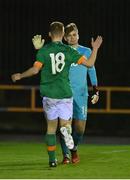 30 October 2022; James Roche of Republic of Ireland, 18, celebrates with goalkeeper Joe Collins after their side's victory in the penalty shoot-out of the Victory Shield match between Republic of Ireland and Wales at the RSC in Waterford. Photo by Seb Daly/Sportsfile