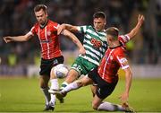 30 October 2022; Justin Ferizaj of Shamrock Rovers in action against Cameron Dummigan, left, and Ronan Boyce of Derry City during the SSE Airtricity League Premier Division match between Shamrock Rovers and Derry City at Tallaght Stadium in Dublin. Photo by Stephen McCarthy/Sportsfile