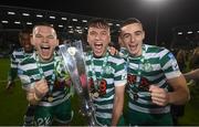 30 October 2022; Shamrock Rovers players, from left, Andy Lyons, Justin Ferizaj and Simon Power celebrate with the SSE Airtricity League Premier Division trophy after the SSE Airtricity League Premier Division match between Shamrock Rovers and Derry City at Tallaght Stadium in Dublin. Photo by Stephen McCarthy/Sportsfile
