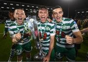 30 October 2022; Shamrock Rovers players, from left, Andy Lyons, Justin Ferizaj and Simon Powercelebrate with the SSE Airtricity League Premier Division trophy after the SSE Airtricity League Premier Division match between Shamrock Rovers and Derry City at Tallaght Stadium in Dublin. Photo by Stephen McCarthy/Sportsfile