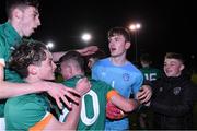 1 November 2022; Republic of Ireland goalkeeper Marcus Gill is congratulated by team-mates after his 3 penalty saves during the penalty shoutout after fill time at the Victory Shield match between Republic of Ireland and Northern Ireland at Tramore AFC in Tramore, Waterford. Photo by Matt Browne/Sportsfile