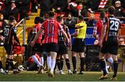 6 November 2022; Referee Rob Hennessy issues a red card to Sadou Diallo of Derry City, left, during the SSE Airtricity League Premier Division match between Derry City and Dundalk at The Ryan McBride Brandywell Stadium in Derry. Photo by Ben McShane/Sportsfile
