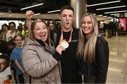 7 November 2022; Gold medallist Rhys McClenaghan of Ireland with his mother Tracy and girlfriend Emily Carr on his return from the World Artistic Gymnastics Championships 2022, at Dublin Airport in Dublin. Photo by David Fitzgerald/Sportsfile