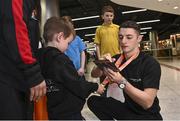 7 November 2022; Gold medallist Rhys McClenaghan of Ireland with Lincoln Healy, age 4, from Pheonix Gymnastics club on his return from the World Artistic Gymnastics Championships 2022, at Dublin Airport in Dublin. Photo by David Fitzgerald/Sportsfile