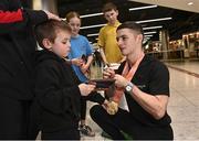7 November 2022; Gold medallist Rhys McClenaghan of Ireland with Lincoln Healy, age 4, from Pheonix Gymnastics club on his return from the World Artistic Gymnastics Championships 2022, at Dublin Airport in Dublin. Photo by David Fitzgerald/Sportsfile