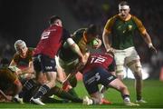 10 November 2022; Elrigh Louw of South Africa Select XV is tackled by Rory Scannell, right, and Diarmuid Barron of Munster during the match between Munster and South Africa Select XV at Páirc Ui Chaoimh in Cork. Photo by David Fitzgerald/Sportsfile