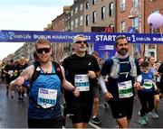 30 October 2022; Runners, from left, Ryan Walsh from Dublin, John Daly from Wexford, and Kevin Purcell from Galway, compete in the 2022 Irish Life Dublin Marathon. 25,000 runners took to the Fitzwilliam Square start line to participate in the 41st running of the Dublin Marathon after a two-year absence. Photo by Sam Barnes/Sportsfile