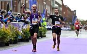30 October 2022; Norman Mawhinney from Down, left, and Paul Brennan from Antrim celebrate on their way to finishing the 2022 Irish Life Dublin Marathon. 25,000 runners took to the Fitzwilliam Square start line to participate in the 41st running of the Dublin Marathon after a two-year absence. Photo by Sam Barnes/Sportsfile