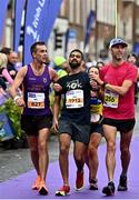 30 October 2022; Sameer Rane from Blackrock AC, Dublin, is helped to the finish line by Bobby Redmond from Wexford, left, and Alastair Higgins from Dublin Bay Running Club, right, during the 2022 Irish Life Dublin Marathon. 25,000 runners took to the Fitzwilliam Square start line to participate in the 41st running of the Dublin Marathon after a two-year absence. Photo by Sam Barnes/Sportsfile