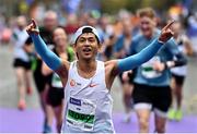 30 October 2022; Feng Han from Dublin celebrates finishing the 2022 Irish Life Dublin Marathon. 25,000 runners took to the Fitzwilliam Square start line to participate in the 41st running of the Dublin Marathon after a two-year absence. Photo by Sam Barnes/Sportsfile