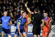 11 November 2022; Jack Keaney of UCD is shown a yellow card by referee Rob Harvey during the SSE Airtricity League Promotion / Relegation Play-off match between UCD and Waterford at Richmond Park in Dublin. Photo by Seb Daly/Sportsfile