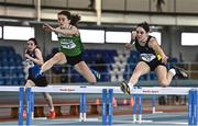 12 November 2022; Aoife Callan of St Brogans College Bandon, Cork, right, and Ella Carey of Loreto Foxrock, Dublin, compete in the intermediate girls 60m hurdles during the 123.ie All-Ireland Schools’ Combined Events at TUS International Arena in Athlone, Westmeath. Photo by Sam Barnes/Sportsfile