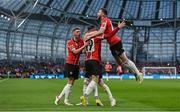 13 November 2022; Jamie McGonigle of Derry City, hidden celebrates with teammates, including Will Patching, right, and Ryan Graydon, 19, after scoring their side's first goal during the Extra.ie FAI Cup Final match between Derry City and Shelbourne at the Aviva Stadium in Dublin. Photo by Seb Daly/Sportsfile