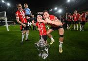13 November 2022; Will Patching of Derry City and Derry City supporter Braelin Diver celebrates with the FAI Senior Challenge Cup afetr the Extra.ie FAI Cup Final match between Derry City and Shelbourne at Aviva Stadium in Dublin. Photo by Stephen McCarthy/Sportsfile