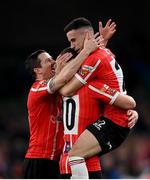 13 November 2022; Jordan McEneff, right, celebrates with Derry City team-mates Ciaran Coll, left, and Patrick McEleney after scoring their side's fourth goal during the Extra.ie FAI Cup Final match between Derry City and Shelbourne at Aviva Stadium in Dublin. Photo by Stephen McCarthy/Sportsfile
