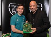 14 November 2022; Josh Cullen is presented with his 2021-2022 Republic of Ireland international cap by former Republic of Ireland player Paul McGrath during a presentation at their team hotel in Dublin. Photo by Seb Daly/Sportsfile