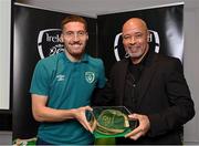 14 November 2022; Matt Doherty is presented with his 2021-2022 Republic of Ireland international cap by former Republic of Ireland player Paul McGrath during a presentation at their team hotel in Dublin. Photo by Seb Daly/Sportsfile