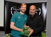 14 November 2022; Caoimhin Kelleher is presented with his 2021-2022 Republic of Ireland international cap by former Republic of Ireland player Paul McGrath during a presentation at their team hotel in Dublin. Photo by Seb Daly/Sportsfile