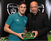 14 November 2022; Jamie McGrath is presented with his 2021-2022 Republic of Ireland international cap by former Republic of Ireland player Paul McGrath during a presentation at their team hotel in Dublin. Photo by Seb Daly/Sportsfile