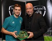 14 November 2022; Jayson Molumby is presented with his 2021-2022 Republic of Ireland international cap by former Republic of Ireland player Paul McGrath during a presentation at their team hotel in Dublin. Photo by Seb Daly/Sportsfile