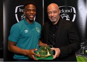 14 November 2022; Chiedozie Ogbene is presented with his 2021-2022 Republic of Ireland international cap by former Republic of Ireland player Paul McGrath during a presentation at their team hotel in Dublin. Photo by Seb Daly/Sportsfile