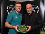 14 November 2022; Dara O'Shea is presented with his 2021-2022 Republic of Ireland international cap by former Republic of Ireland player Paul McGrath during a presentation at their team hotel in Dublin. Photo by Seb Daly/Sportsfile