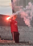 13 November 2022; A Ballybay Pearse Brothers supporter lights a flare after his side socred a goal during the AIB Ulster GAA Football Senior Club Championship Quarter-Final match between Kilcoo and Ballybay Pearse Brothers at St Tiernach's Park in Clones, Monaghan. Photo by Brendan Moran/Sportsfile