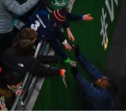 17 November 2022; Michael Obafemi of Republic of Ireland signs autographs for supporters after the International Friendly match between Republic of Ireland and Norway at the Aviva Stadium in Dublin. Photo by Ben McShane/Sportsfile