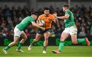 19 November 2022; Tom Wright of Australia is tackled by Jimmy O'Brien, left, and Stuart McCloskey of Ireland during the Bank of Ireland Nations Series match between Ireland and Australia at the Aviva Stadium in Dublin. Photo by David Fitzgerald/Sportsfile