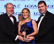 19 November 2022; TG4 Senior Players Player of the Year Niamh McLaughlin of Donegal is presented with her award by Ard Stiúrthóir TG4 Alan Esslemont, left, and President of the LGFA Mícheál Naughton during the TG4 All-Ireland Ladies Football All Stars Awards banquet, in association with Lidl, at the Bonnington Dublin Hotel. Photo by Eóin Noonan/Sportsfile