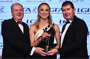 19 November 2022; Aoibhín Cleary of Meath is presented with her TG4 LGFA All Star award by Ard Stiúrthóir TG4 Alan Esslemont, left, and President of the LGFA Mícheál Naughton during the TG4 All-Ireland Ladies Football All Stars Awards banquet, in association with Lidl, at the Bonnington Dublin Hotel. Photo by Eóin Noonan/Sportsfile