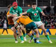 19 November 2022; Josh van der Flier of Ireland is tackled by Michael Hooper and Len Ikitau of Australia during the Bank of Ireland Nations Series match between Ireland and Australia at the Aviva Stadium in Dublin. Photo by John Dickson/Sportsfile