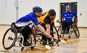 20 November 2022; Cian Horgan of Munster in action against Ciarán Bradley of Ulster during the M.Donnelly GAA Wheelchair Hurling / Camogie All-Ireland Finals 2022 match between Ulster and Munster at Ashbourne Community School in Ashbourne, Meath. Photo by Eóin Noonan/Sportsfile