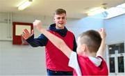 24 November 2022; Republic of Ireland international Evan Ferguson with pupils from Scoil Chiaráin  during the launch of Football for All - Futsal in the Yard programme at the Scoil Chiaráin in Glasnevin, Dublin. Photo by Eóin Noonan/Sportsfile