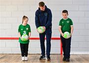 24 November 2022; Republic of Ireland international Evan Ferguson with pupils Cillian Walsh and Roisin O'Reilly from Scoil Chiaráin during the launch of Football for All - Futsal in the Yard programme at the Scoil Chiaráin in Glasnevin, Dublin. Photo by Eóin Noonan/Sportsfile