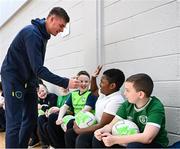 24 November 2022; Republic of Ireland international Evan Ferguson with pupils from Scoil Chiaráin  during the launch of Football for All - Futsal in the Yard programme at the Scoil Chiaráin in Glasnevin, Dublin. Photo by Eóin Noonan/Sportsfile